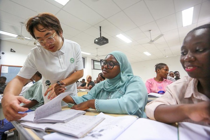 Chinese volunteer teacher Liu Mu guides a student during a class at the Confucius Institute at the University of Dar es Salaam in Dar es Salaam, Tanzania, Oct. 1, 2026. (Xinhua/Emmanuel Herman)